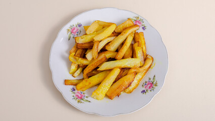 Fries on plate top view isolated