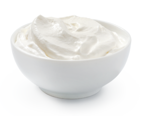 Sour cream or yogurt in white bowl isolated