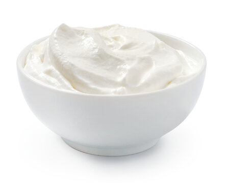 Sour cream or yogurt in white bowl isolated