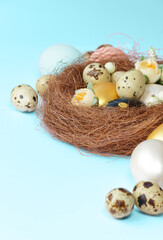 Easter eggs in a nest on a blue background. Copy space. Easter day.