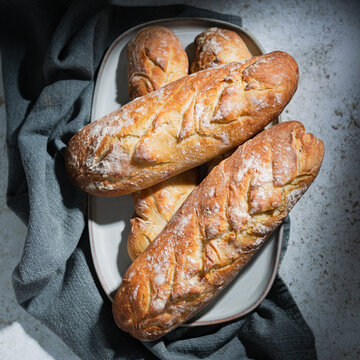 Overhead view of four loaves of homemade bread on a plate