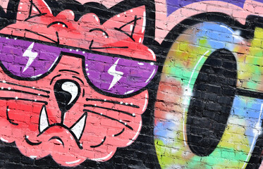 Colorful background of graffiti painting artwork with bright aerosol outlines on wall. Old school...