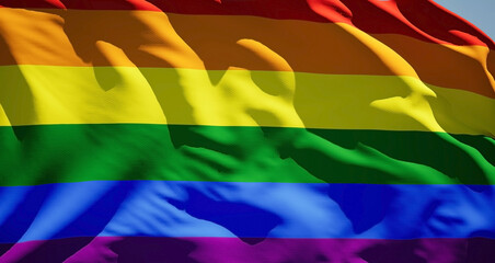 Rainbow LGBT pride flag waving in wind. Realistic Gay fabric background. International Day Against Homophobia. Background with rainbow colors