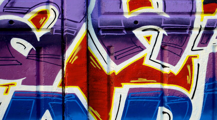 Colorful background of graffiti painting artwork with bright aerosol outlines on wall. Old school...