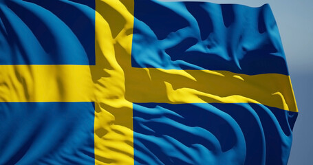Close-up of the national flag of kingdom Sweden flutters in the wind on a sunny day