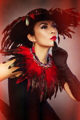 Beautiful woman in fancy feather hat femme fatale