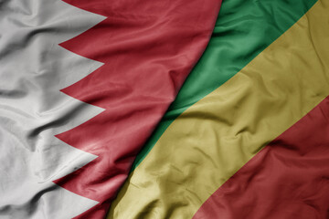 big waving national colorful flag of republic of the congo and national flag of bahrain.