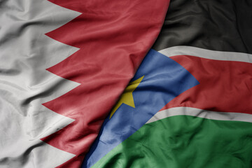 big waving national colorful flag of south sudan and national flag of bahrain.