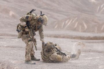 Soldier evacuated the injured fellow  from the mission in desert