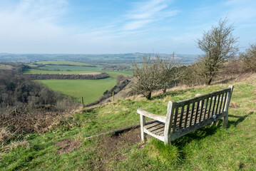 Old wooden bench on Old Winchester hill in Hampshire, England with a wonderful view across the countryside. 