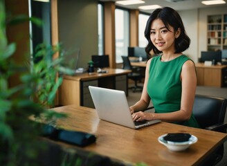 Confident Asian businesswoman with a laptop exuding a sense of leadership and empowerment