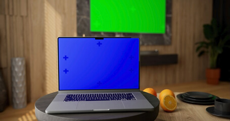Laptop place on room table, Green and blue screen display TV, Close up monitor of notebook with mock up