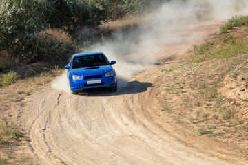 Fototapeta na wymiar Rally Car in a Turn and a Cloud of Dust 18