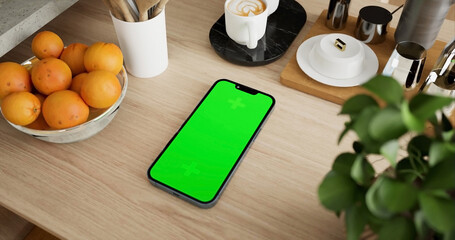 Smartphone place on kitchen table, Green screen telephone, Close up display mobile phone with mock up, Chroma key monitor - 756591491