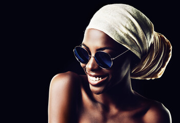 Happy, black woman and sunglasses with scarf for fashion or style on a dark studio background....