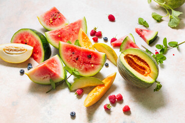 Various types of tasty ripe watermelon and melons with berry.