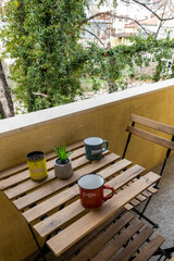 Coffee cup on table for french breakfast in the morning on a balcony. A concept for relaxing time. Beautiful nature view at the background.