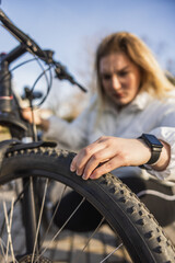 Close Up of a Woman Checking Bike Tire