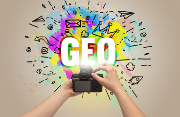 Close-up of a hand holding digital camera with abstract drawing