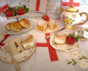 Celebrating St Georges day  England   afternoon team  vintage  victoria  sponge  strawberries and  cream scones bunting   england flag 