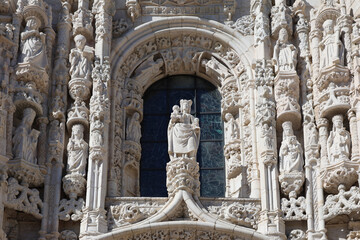 Jeronimos Monastery in Lisbon and Santa Maria de Belem Church landmark buildings in a photo during a sunny day with blue sky. Travel to Lisbon, Portugal. - obrazy, fototapety, plakaty