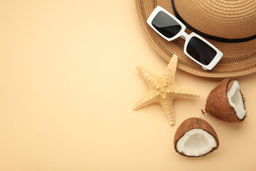 Summer accessories with coconuts on beige background.