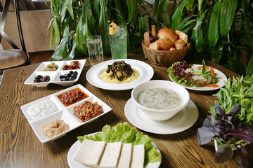 Wooden Table Adorned With Plates of Appetizing Food.
