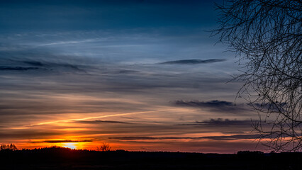 Fototapeta premium Autumn sunset seen through trees in Podlasie.