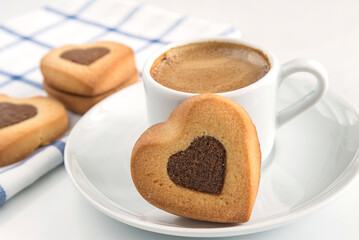 Coffee break concept/cup of coffee and cookies shaped heart on white background