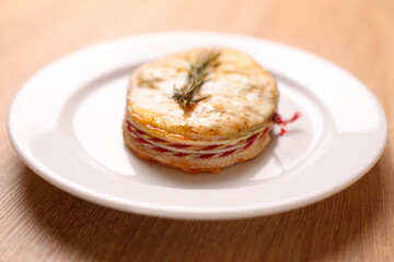 A freshly baked piece of salmon is placed on a plate and sauce is added