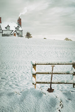 Snow Covered Fence With Shovel