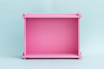 Vibrant Pink Wooden Box Against Light Blue Background, Minimalist Design