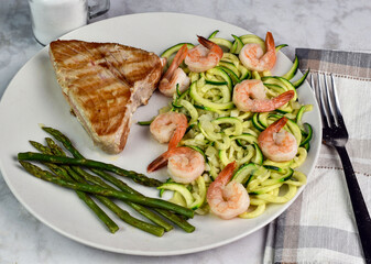 tuna steak served with zucchini noodle top with shrimp,