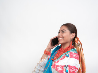 happy ecuadorian hispanic girl with typical cayambeño costume, making a call, with copy space and...