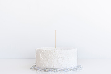 Cake topper mock up . Styled with Silver confetti , ribbons decoration for birthday party celebration.against a white background. Close up birthday , wedding cake topper mockup