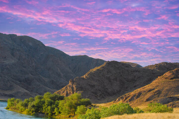 Enjoy a breathtaking sunset in Central Asia. Explore unique rock formations along the river....