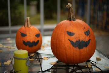 Scary pumpkins on the table. Evil smiles on pumpkins. Preparation for the holiday.