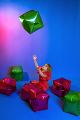 little girl playing with balloons