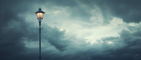 a street lamp with cloudy sky as background .. - obrazy, fototapety, plakaty