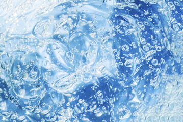 The texture of a transparent gel. A skin or hair care product.
