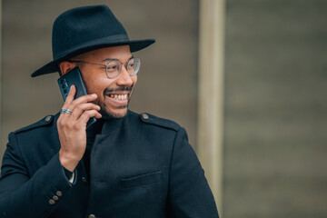 latin man with mobile phone on the street