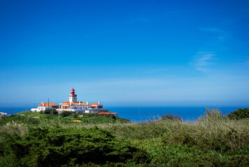 Fototapeta na wymiar Portuguese Coastal Beauty: Cabo da Roca Lighthouse Overlooking the Ocean