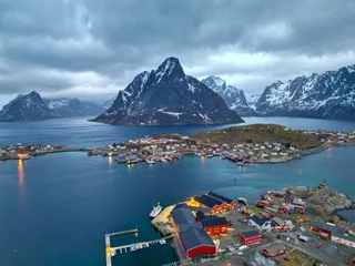 No drill roller blinds Reinefjorden Aerial view of Lofoten island Norway. The winter season of sunrise fishing village of Reine with snowscape mountain peak reflect on water. Norway with red rorbu houses. With falling snow in winter.