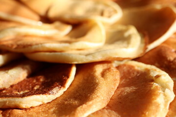Closeup of a stack of pancakes, a staple food in many cuisines