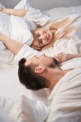 Obraz na płótnie Canvas Happy newlyweds wake up in the honeymoon suite