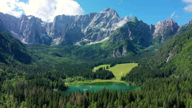 Lake of Fusine (Lago Superiore di Fusine) and the Mountain Range of Mount Mangart, Julian Alps, Tarvisio, Udine province, Friuli Venezia Giulia, Italy, Europe. Picturesque lake Lago Fusine in Italy.