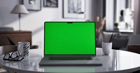 Laptop place on living room table, Green screen display, Close up monitor of notebook with mock up - 756651060