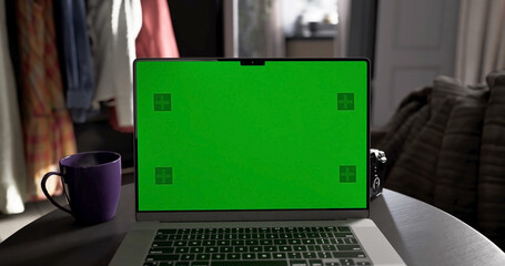 Laptop place on living room table, Green screen display, Close up monitor of notebook with mock up