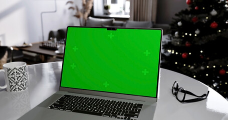 Laptop place on living room table, Christmas and New Year mood, Green screen display, Close up monitor of notebook with mock up - 756652865
