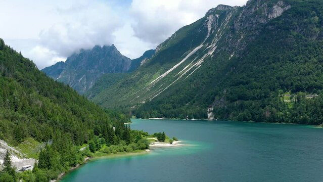 View to Julian Alps mountains above Predil lake in Italy with small lake. Predil Lake, Friuli Italy / (Lago del Predil), beautiful alpine lake in north Italy near the Slovenian border, Italy.